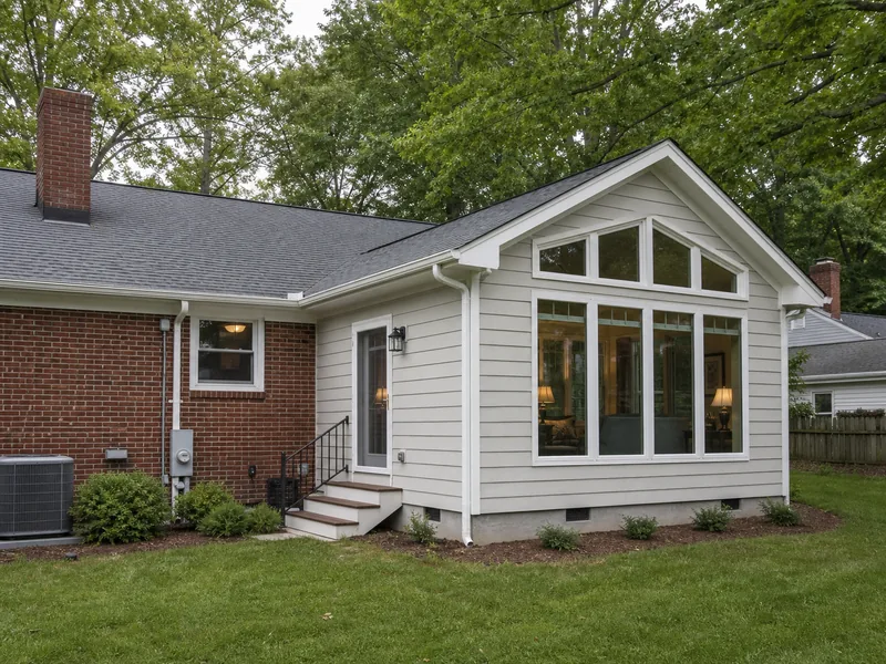 Completed rear family-room addition on a brick home