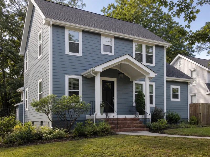 Two-story home with blue-gray siding and renewed entry details